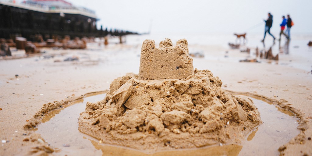 Sand castle on rainy beach