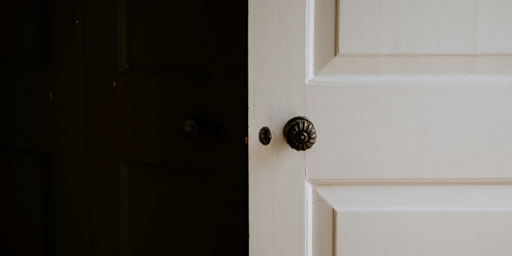 Closeup of White Door on Dark Background