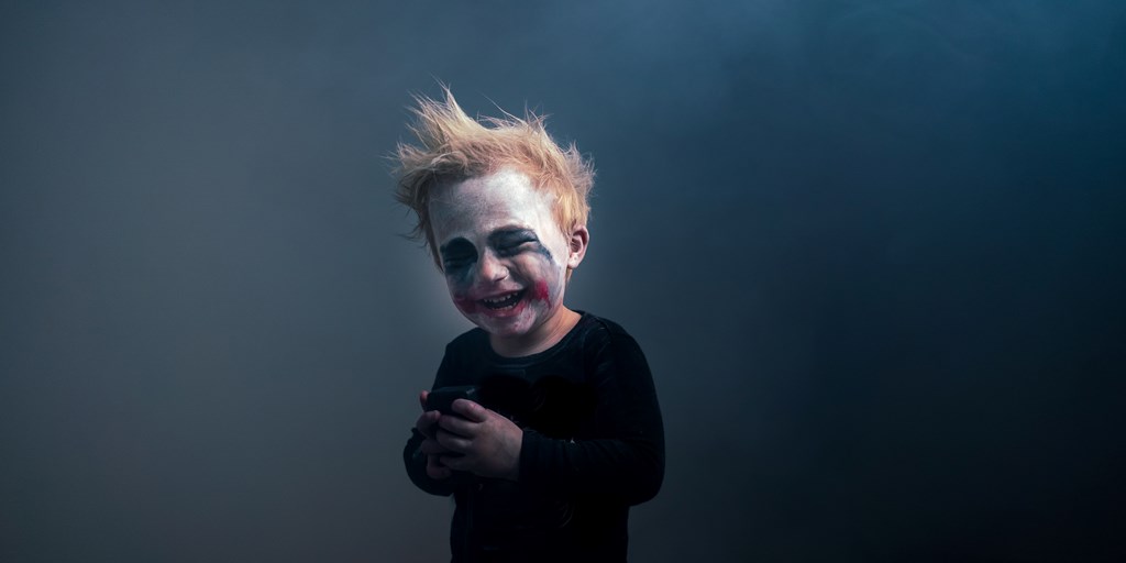 Young Boy with Face painted as Clown