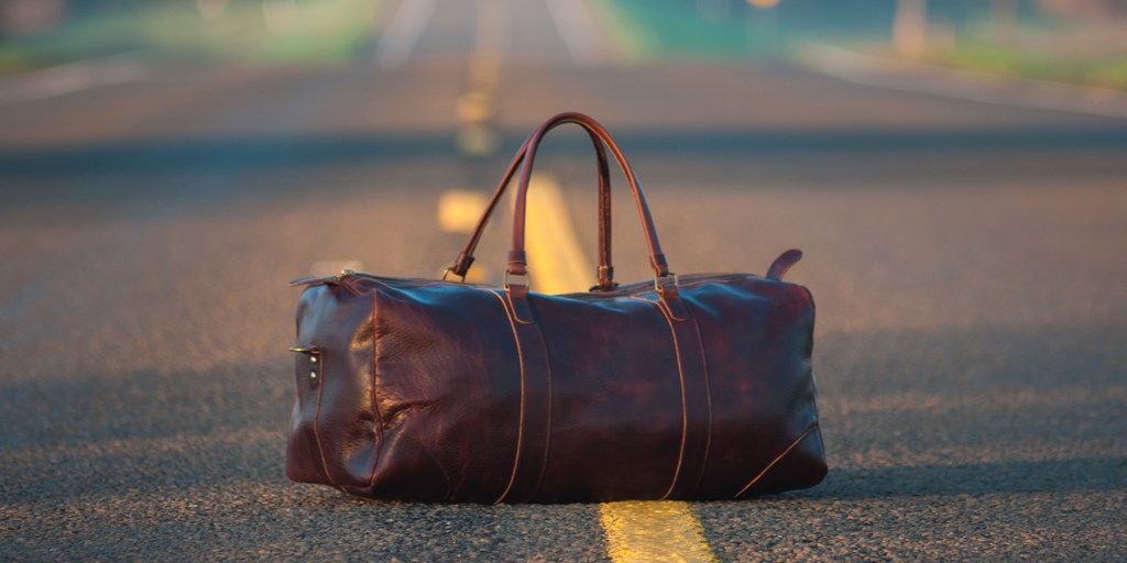 Leather Gym Bag in the Center of a Country Highway